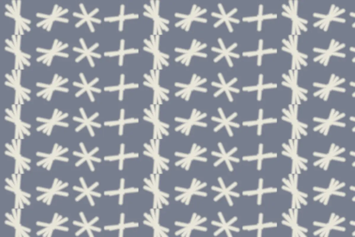 Adire: cream resist-dyed crosses repeating across grey-blue cloth.